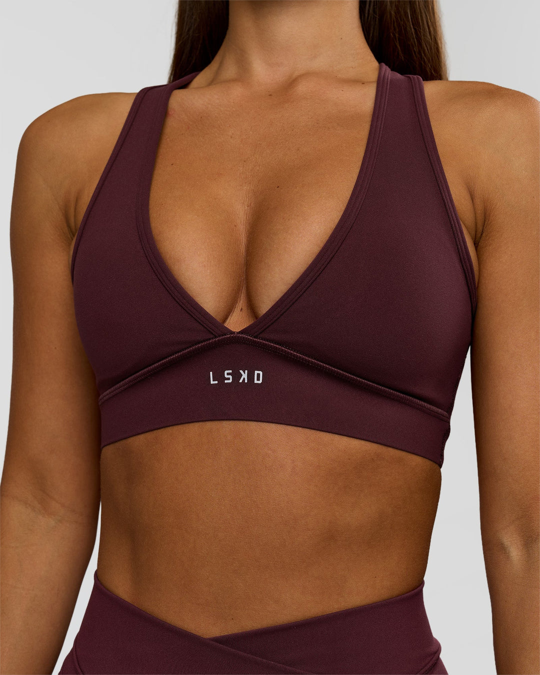 Woman wearing Stamina Sports Bra - Cherry Lacquer | Model:Brylee | Size:XS - view 3
