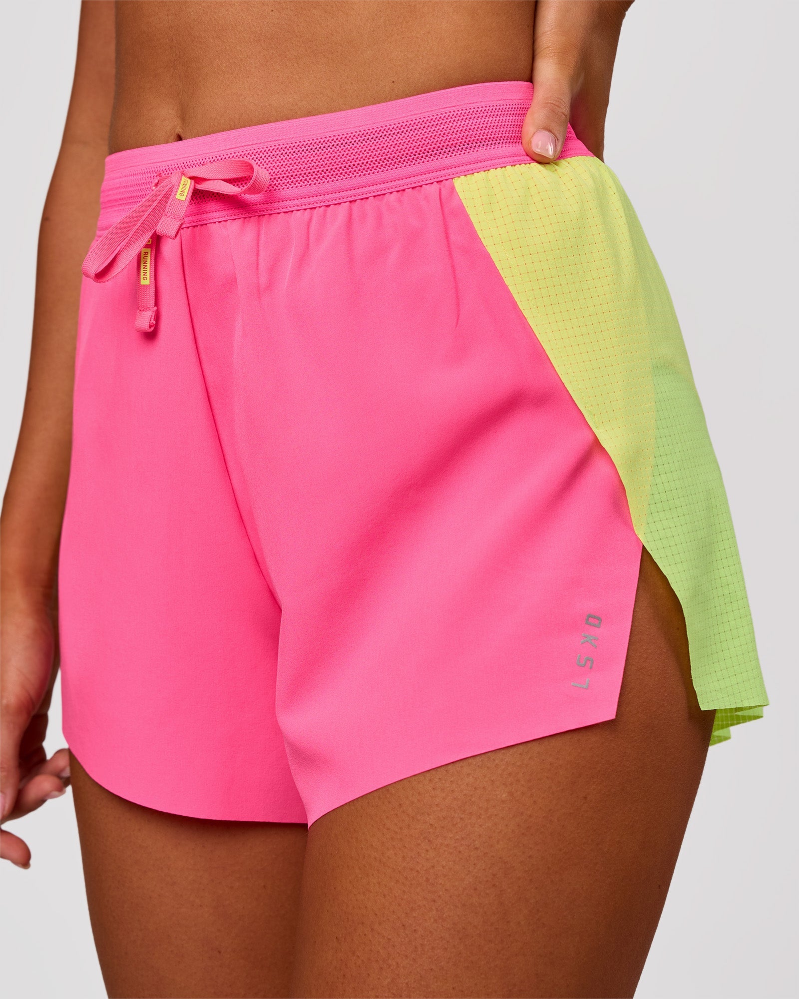Woman wearing Accelerate 3" High-Rise Running Short - Lime Glo-Sugar Plum | Model:Charli | Size:XS