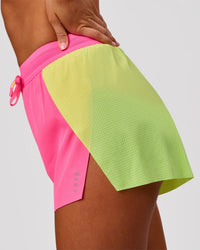 Woman wearing Accelerate 3" High-Rise Running Short - Lime Glo-Sugar Plum | Model:Charli | Size:XS | Thumbnail Index: 3