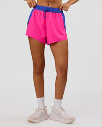Woman wearing Accelerate 3" High-Rise Running Short - Power Cobalt-Ultra Pink | Model:Charli | Size:XS | Thumbnail Index: 5