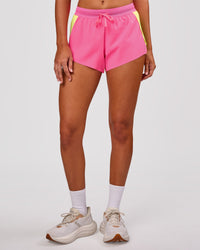Woman wearing Accelerate 3" Mid-Rise Running Short - Lime Glo-Sugar Plum | Model:Charli | Size:XS | Thumbnail Index: 12