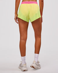 Woman wearing Accelerate 3" Mid-Rise Running Short - Lime Glo-Sugar Plum | Model:Charli | Size:XS | Thumbnail Index: 5