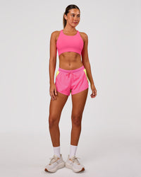 Woman wearing Accelerate 3" Mid-Rise Running Short - Lime Glo-Sugar Plum | Model:Charli | Size:XS | Thumbnail Index: 2