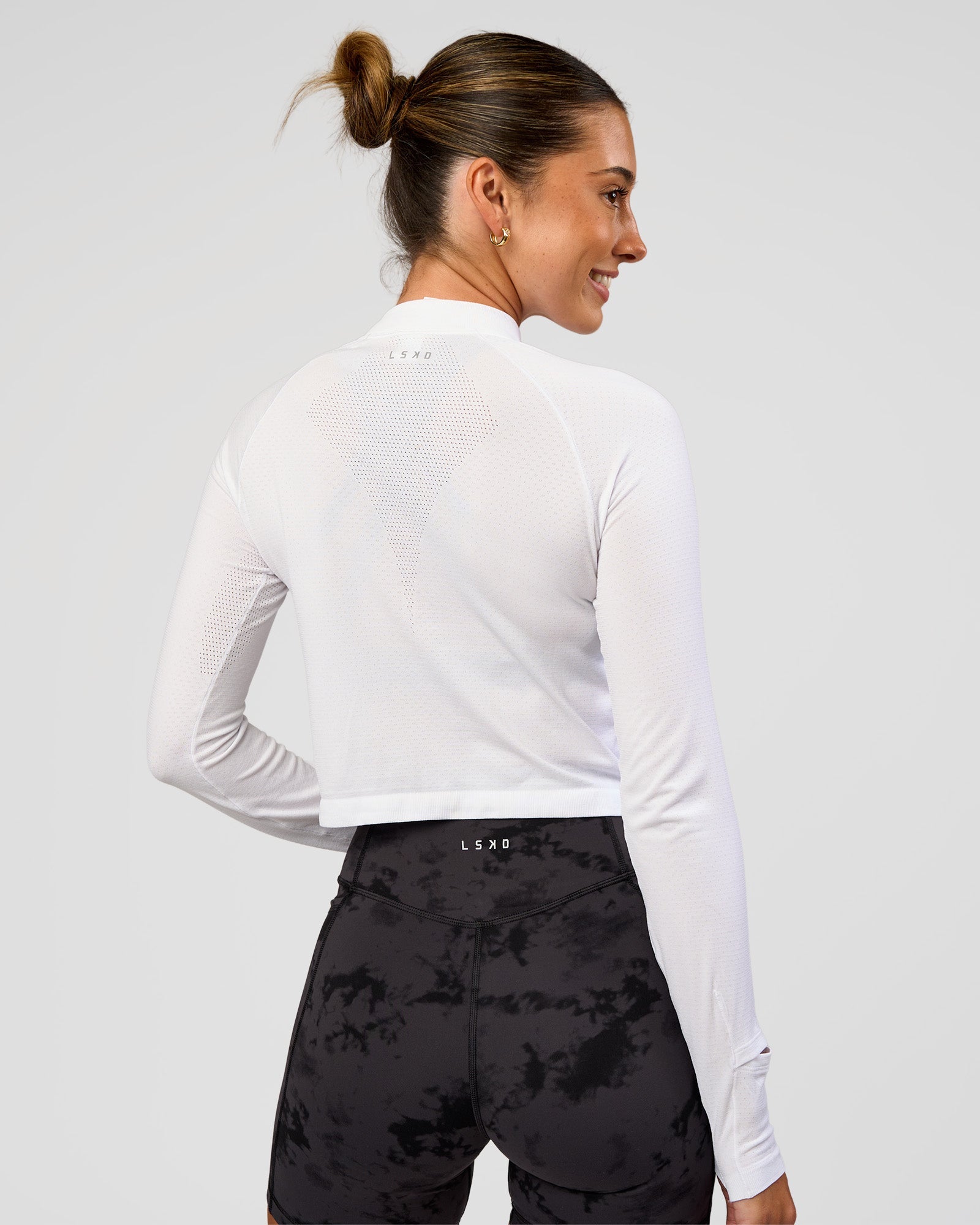 Woman wearing AeroFLX+ Long Sleeve Skimmer Half Zip - White/White | Model:Charli | Size:XS