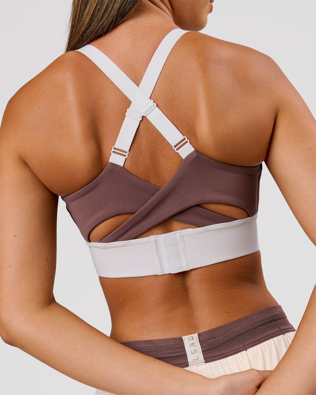 Woman wearing Elevated Accelerate Sports Bra - Cocoa Power-White | Model:Charli | Size:XS - view 3