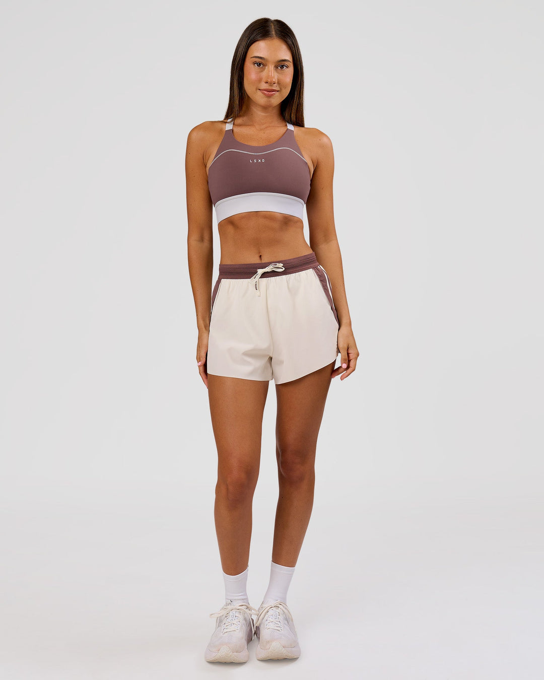 Woman wearing Elevated Accelerate Sports Bra - Cocoa Power-White | Model:Charli | Size:XS - view 4