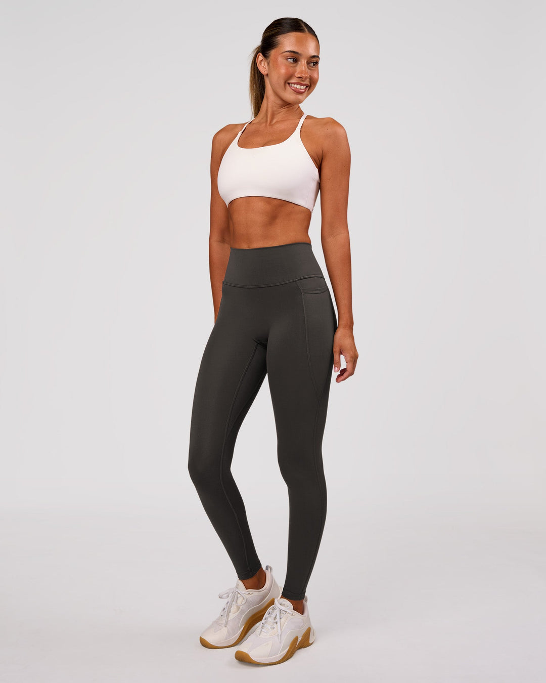 Woman wearing Fusion Ultra High-Rise Full Length Legging Pockets - Onyx | Model:Charli | Size:XS - view 4