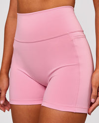 Woman wearing Fusion V-Contour Ultra High-Rise 4" Short Pockets - Pink Rose | Model:Charli | Size:XS | Thumbnail Index: 3