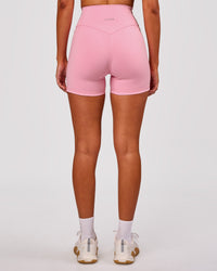 Woman wearing Fusion V-Contour Ultra High-Rise 4" Short Pockets - Pink Rose | Model:Charli | Size:XS | Thumbnail Index: 4