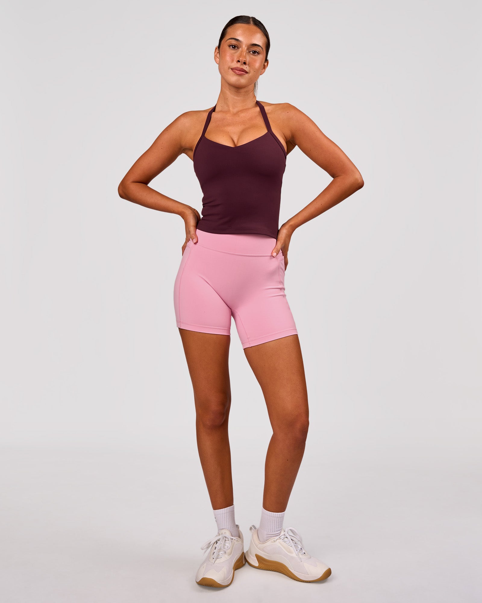 Woman wearing Fusion V-Contour Ultra High-Rise 6" Short Pockets - Pink Rose | Model:Charli | Size:XS