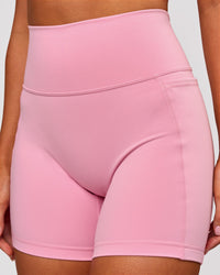 Woman wearing Fusion V-Contour Ultra High-Rise 6" Short Pockets - Pink Rose | Model:Charli | Size:XS | Thumbnail Index: 2