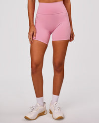 Woman wearing Fusion V-Contour Ultra High-Rise 6" Short Pockets - Pink Rose | Model:Charli | Size:XS | Thumbnail Index: 5