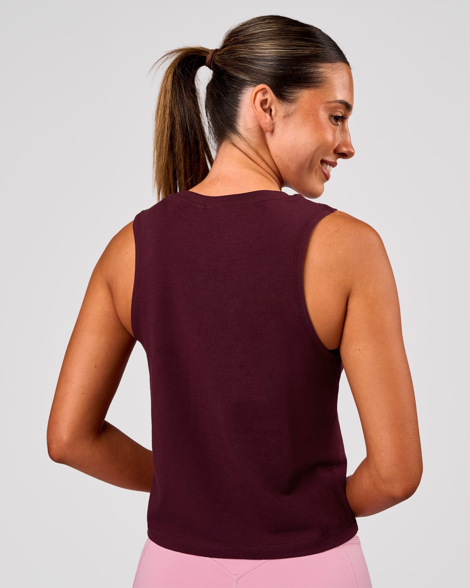 Woman wearing Go-To FLXCotton Midline Tank - Cherry Lacquer-White | Model:Charli | Size:XS