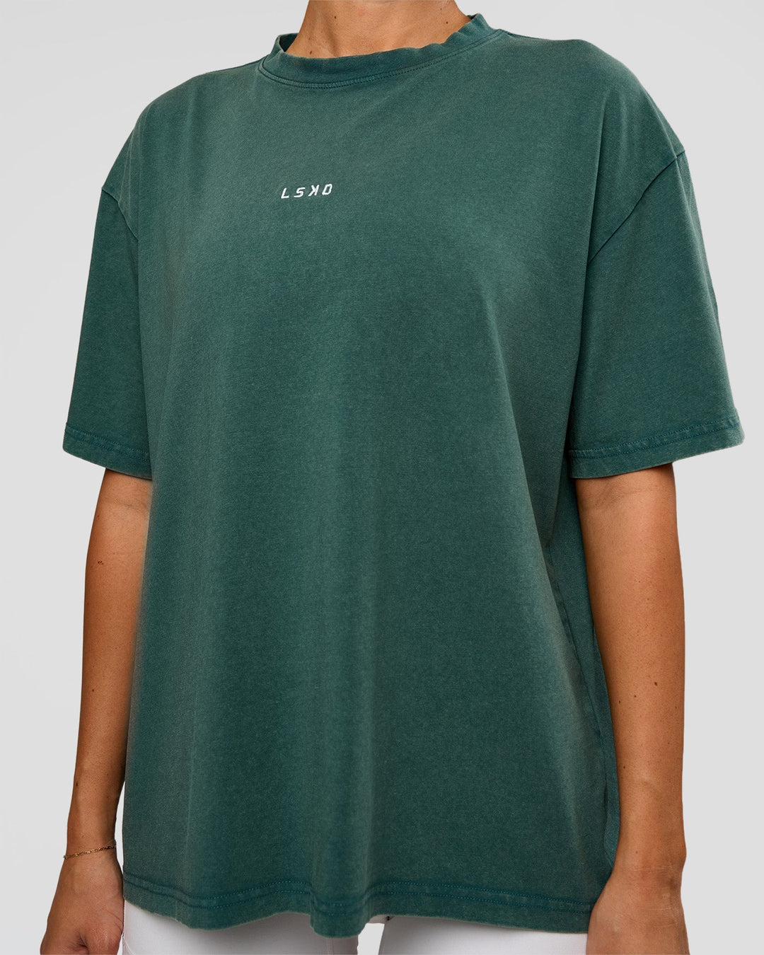 Woman wearing Go-To FLXCotton Oversized Tee - Transformative Teal Washed-White | Model:Charli | Size:XS