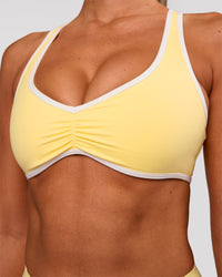 Woman wearing Luminous Sports Bra - Lemon-White | Model:Charli | Size:XS | Thumbnail Index: 0