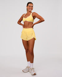 Woman wearing Luminous Sports Bra - Lemon-White | Model:Charli | Size:XS | Thumbnail Index: 4