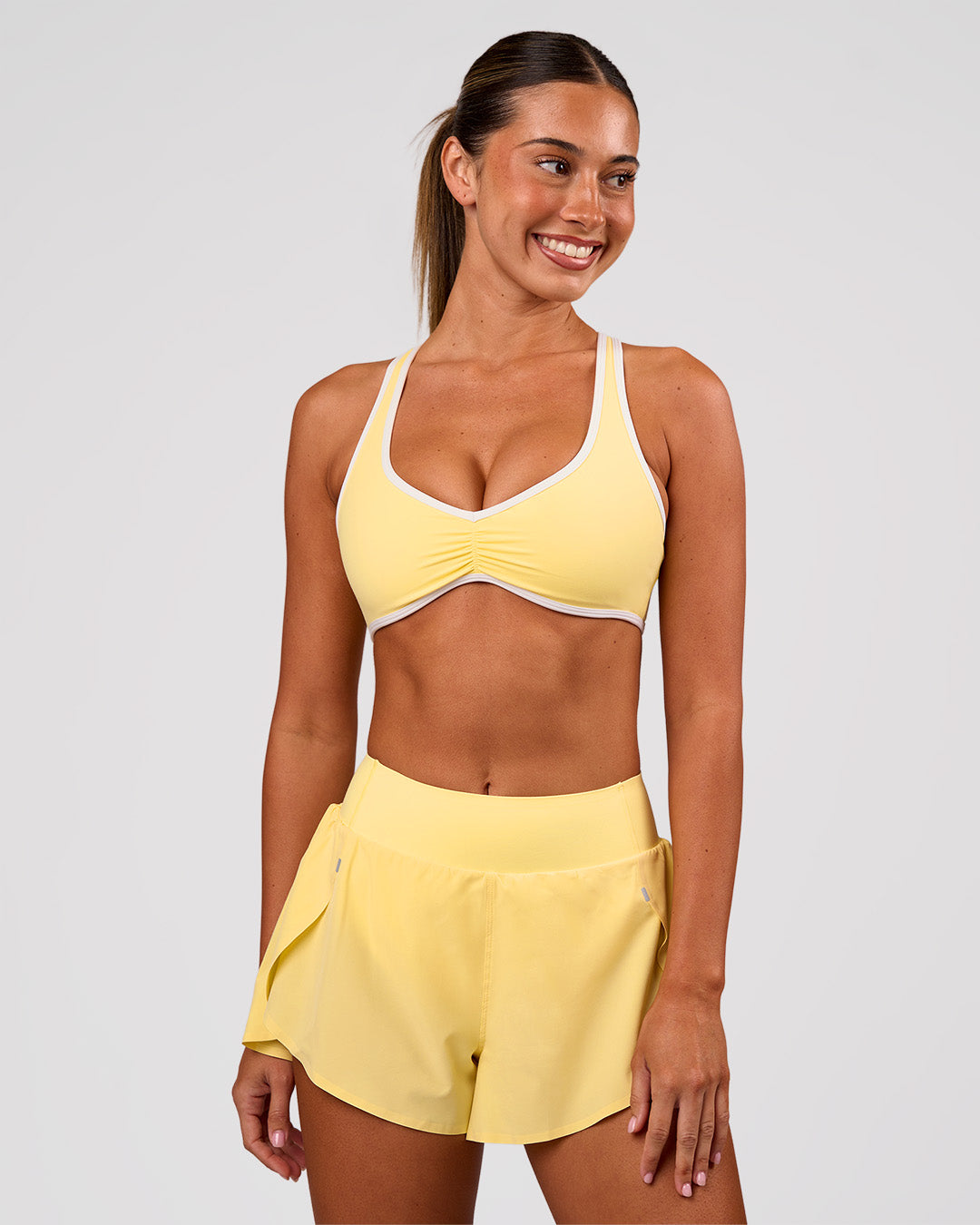 Woman wearing Luminous Sports Bra - Lemon-White | Model:Charli | Size:XS - view 3