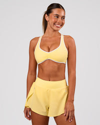 Woman wearing Luminous Sports Bra - Lemon-White | Model:Charli | Size:XS | Thumbnail Index: 2