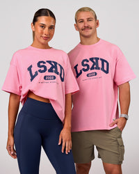 Woman wearing Varsity EST Heavyweight Oversized Tee  - Pink Rose-Future Navy | Model:Charli | Size:XS | Thumbnail Index: 0