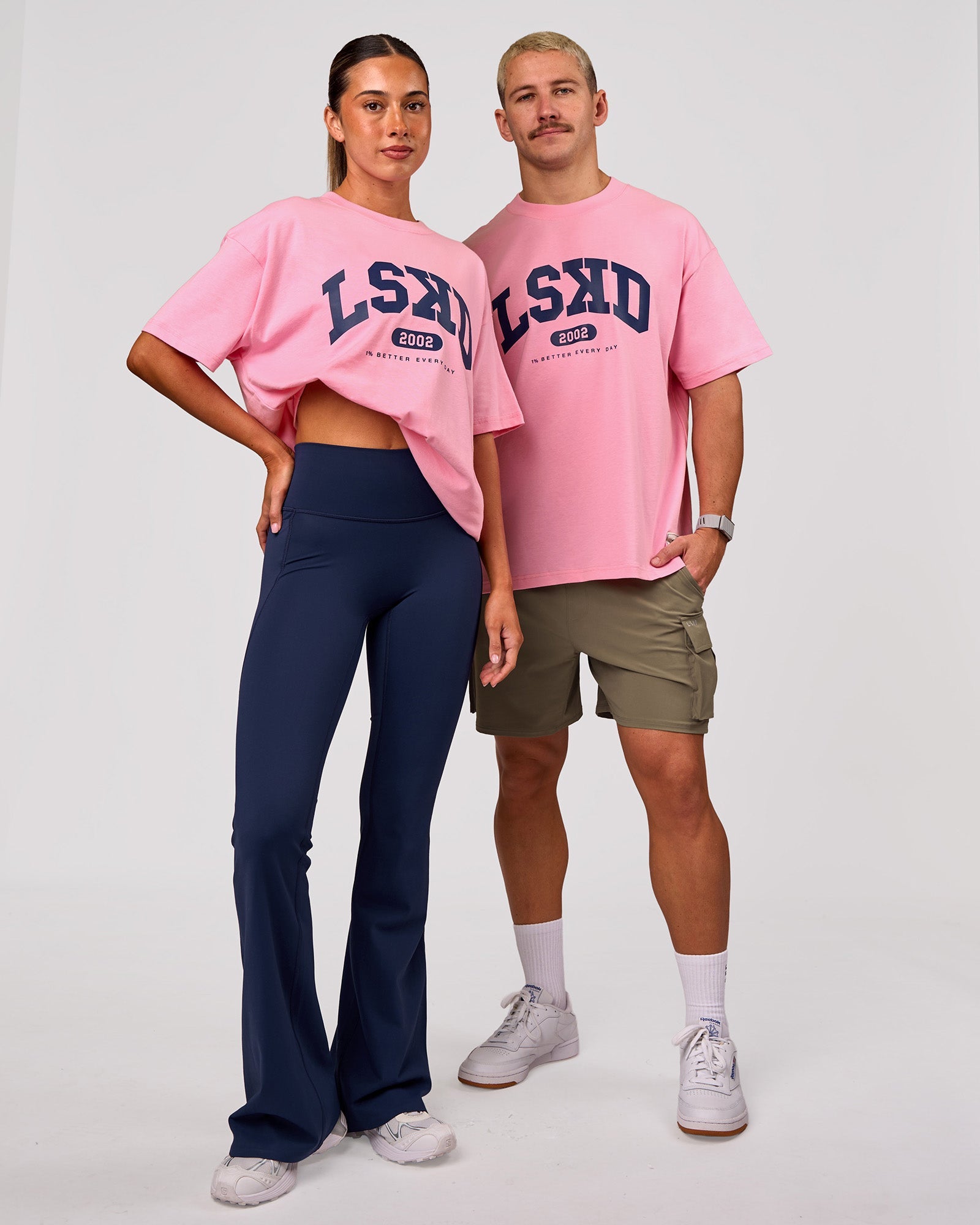 Woman wearing Varsity EST Heavyweight Oversized Tee  - Pink Rose-Future Navy | Model:Charli | Size:XS