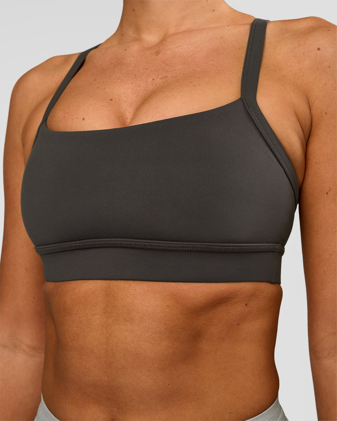 Woman wearing Momentum Sports Bra - Onyx | Model:Charli | Size:XS - view 4