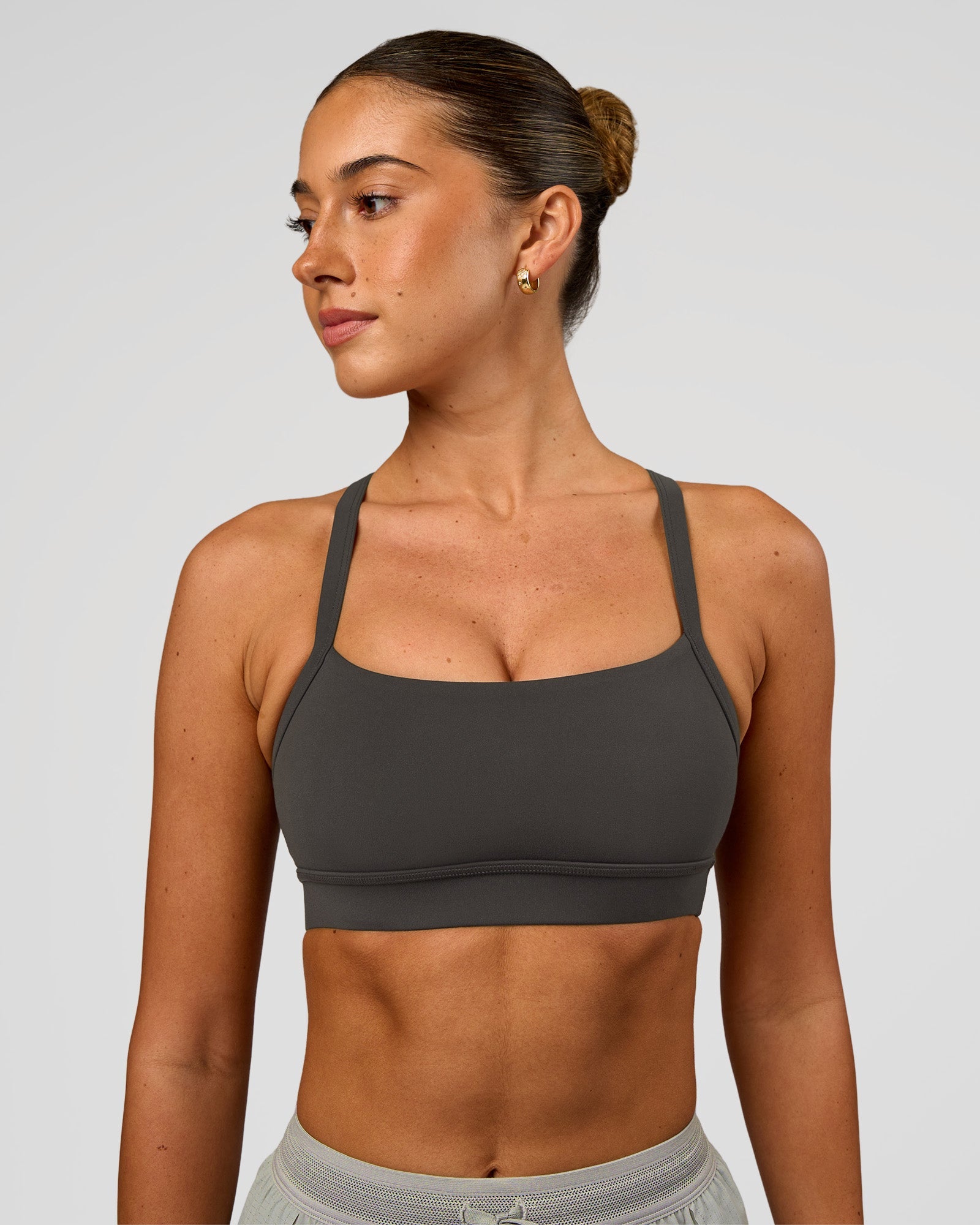 Woman wearing Momentum Sports Bra - Onyx | Model:Charli | Size:XS