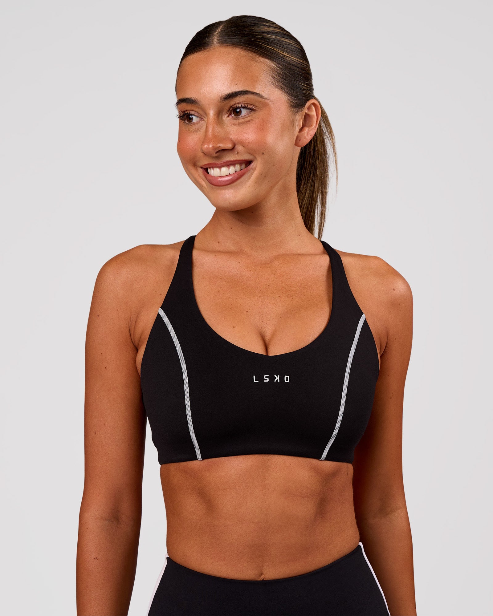 Woman wearing Stellar Sports Bra - Black-White | Model:Charli | Size:XS