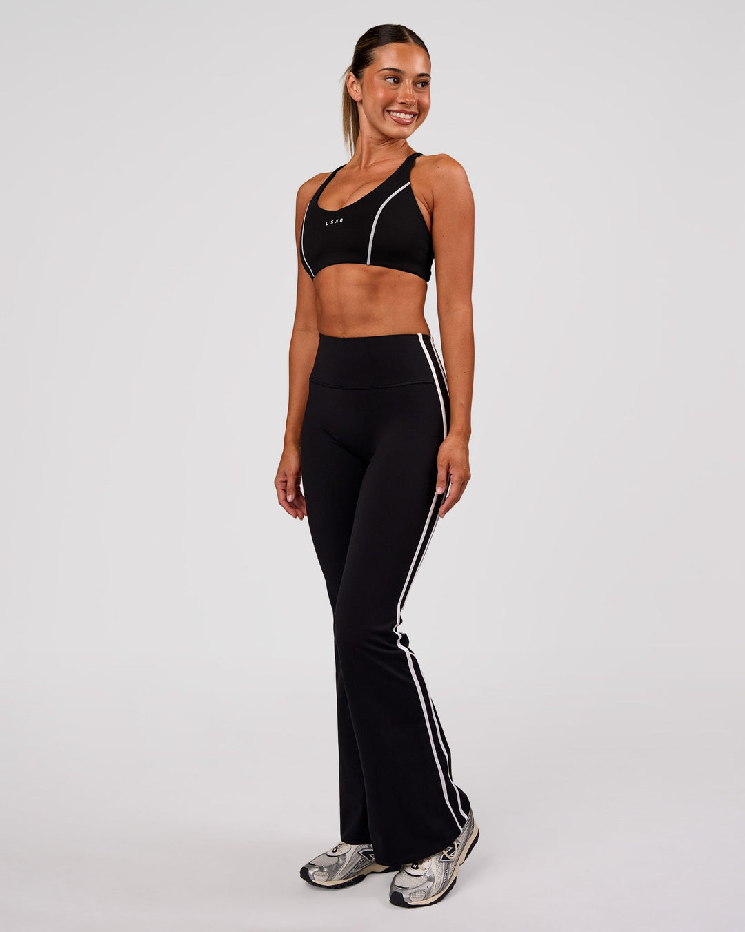 Woman wearing Stellar Sports Bra - Black-White | Model:Charli | Size:XS - view 4