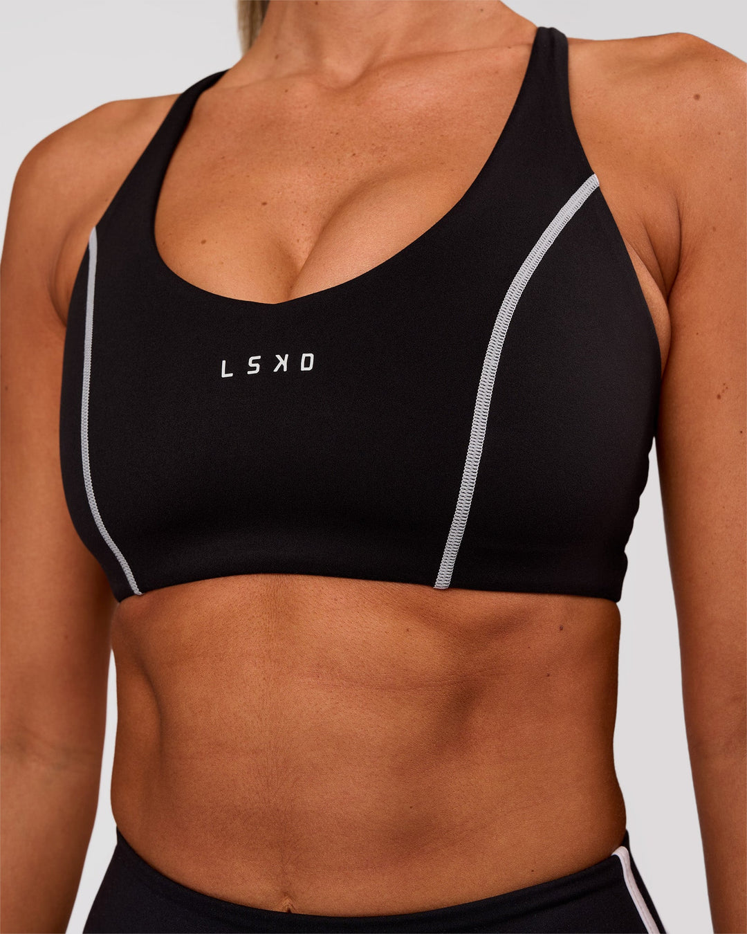 Woman wearing Stellar Sports Bra - Black-White | Model:Charli | Size:XS - view 5
