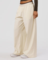 Woman wearing Stride Wide Leg Pant - Vanilla Bean | Model:Charli | Size:XS | Thumbnail Index: 1