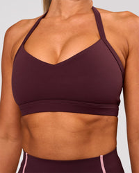 Woman wearing Unleash Sports Bra - Cherry Lacquer | Model:Charli | Size:XS | Thumbnail Index: 0