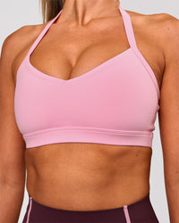 Woman wearing Unleash Sports Bra - Pink Rose | Model:Charli | Size:XS | Thumbnail Index: 1