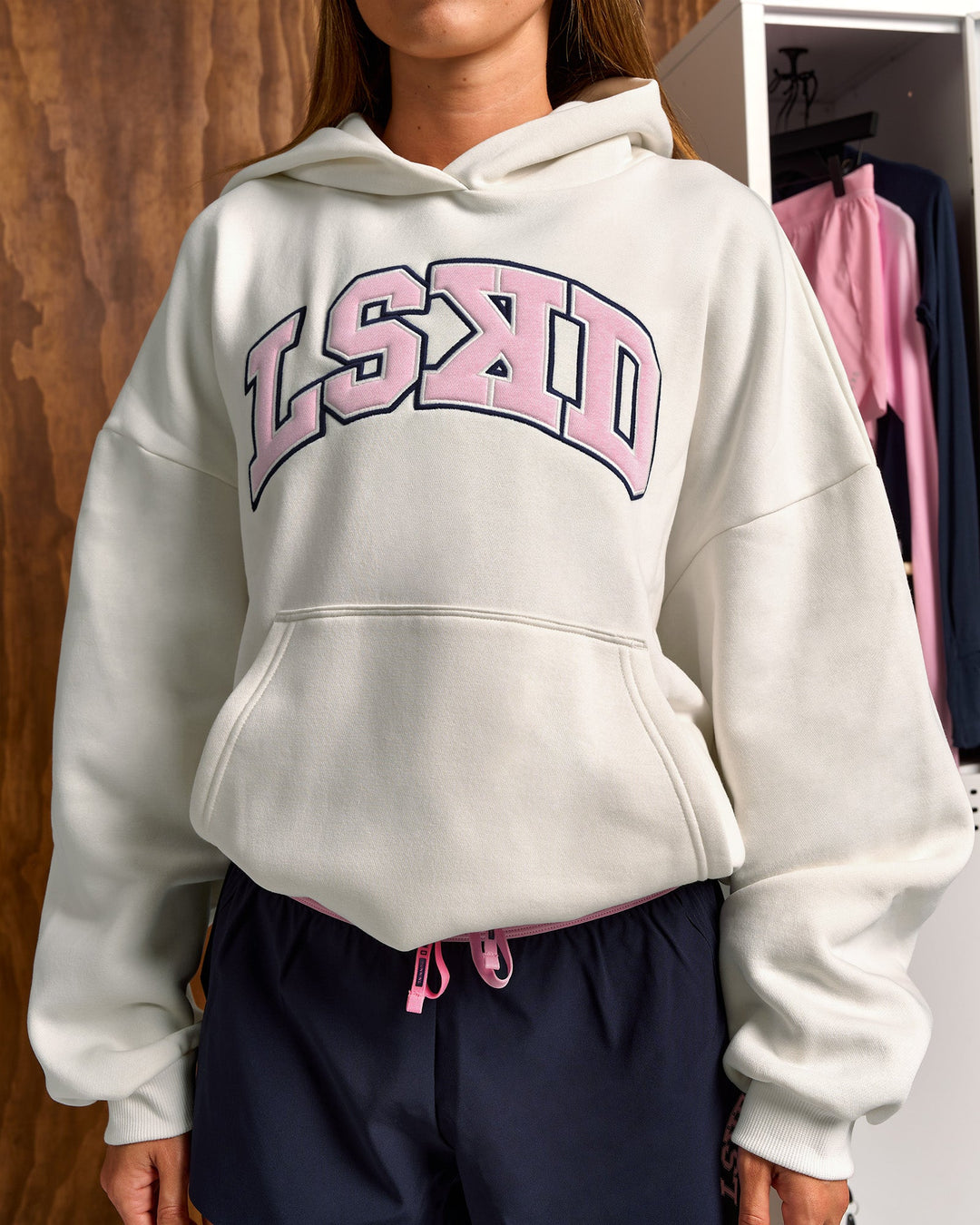 Woman wearing Varsity Boxy Hoodie - Off White-Pink Rose | Model:Charli | Size:XS - view 14