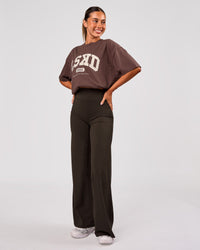Woman wearing Varsity EST Heavyweight Oversized Tee  - Cocoa Powder-Off White | Model:Charli | Size:XS | Thumbnail Index: 10