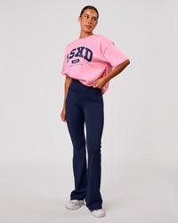 Woman wearing Varsity EST Heavyweight Oversized Tee  - Pink Rose-Future Navy | Model:Charli | Size:XS | Thumbnail Index: 4