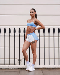 Woman wearing Accelerate 3" Mid-Rise Running Short - Open Air-White | Model:Charlotte | Size:XS | Thumbnail Index: 7