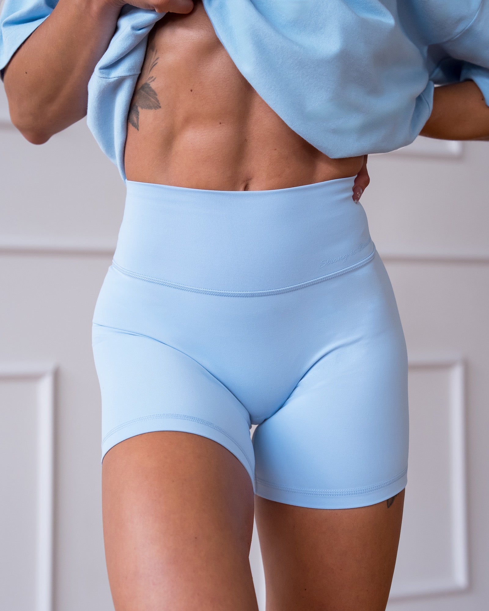 Woman wearing Strong is Beautiful Fusion High-Rise 6" Short - Open Air | Model:Charlotte | Size:XS
