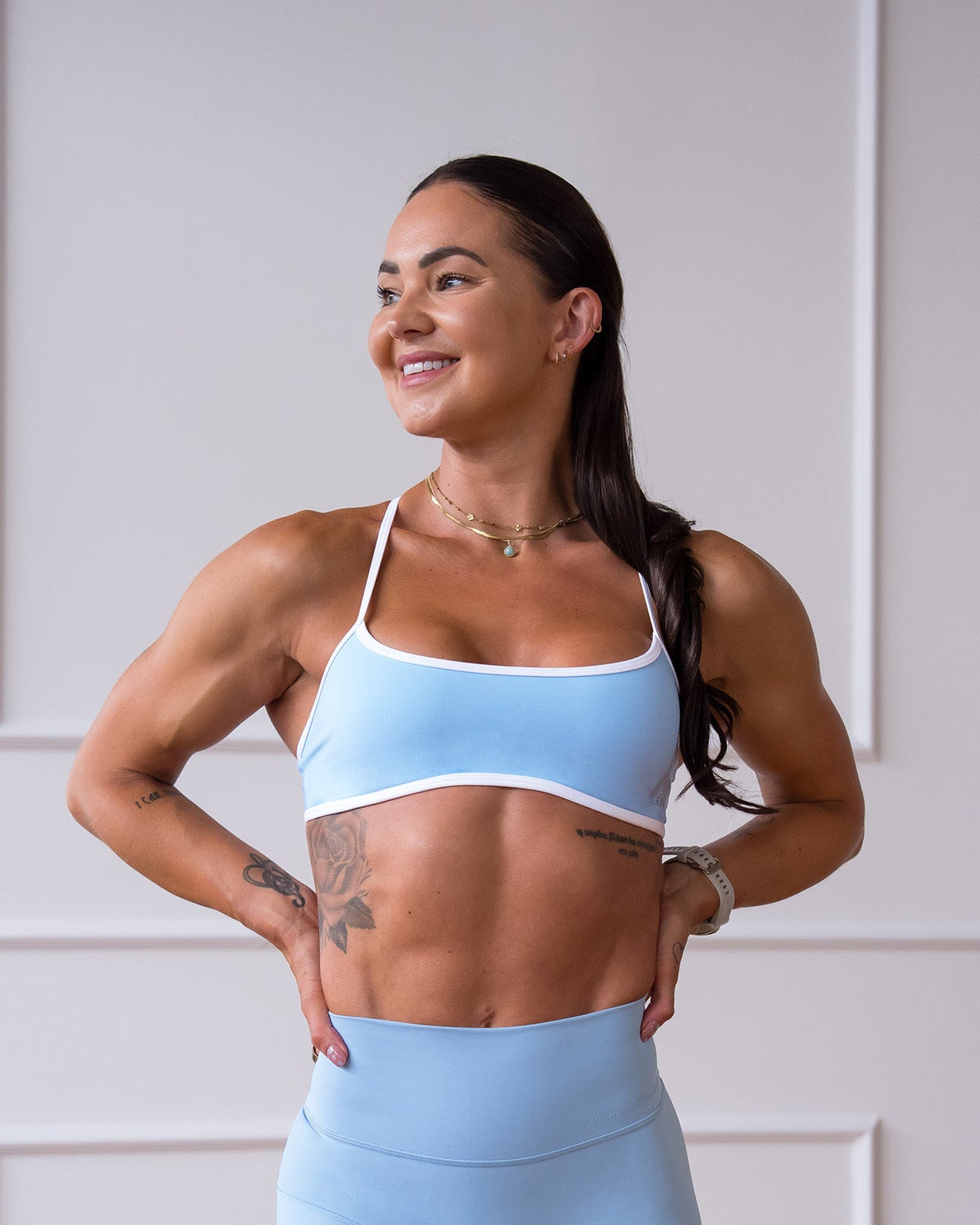 Woman wearing Strong is Beautiful Sports Bra - Open Air-White | Model:Charlotte | Size:XS