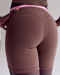 Woman wearing Bree Fusion High-Rise 6" Short Pockets - Cocoa Powder-Pink Rose | Model:Desleigh | Size:XS | Thumbnail Index: 4