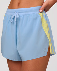 Woman wearing Accelerate 3" Force High-Rise Running Short - Open Air-Lemon | Model:Issy | Size:XS | Thumbnail Index: 0