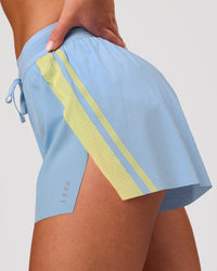 Woman wearing Accelerate 3" Force High-Rise Running Short - Open Air-Lemon | Model:Issy | Size:XS | Thumbnail Index: 2
