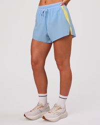 Woman wearing Accelerate 3" Force High-Rise Running Short - Open Air-Lemon | Model:Issy | Size:XS | Thumbnail Index: 4