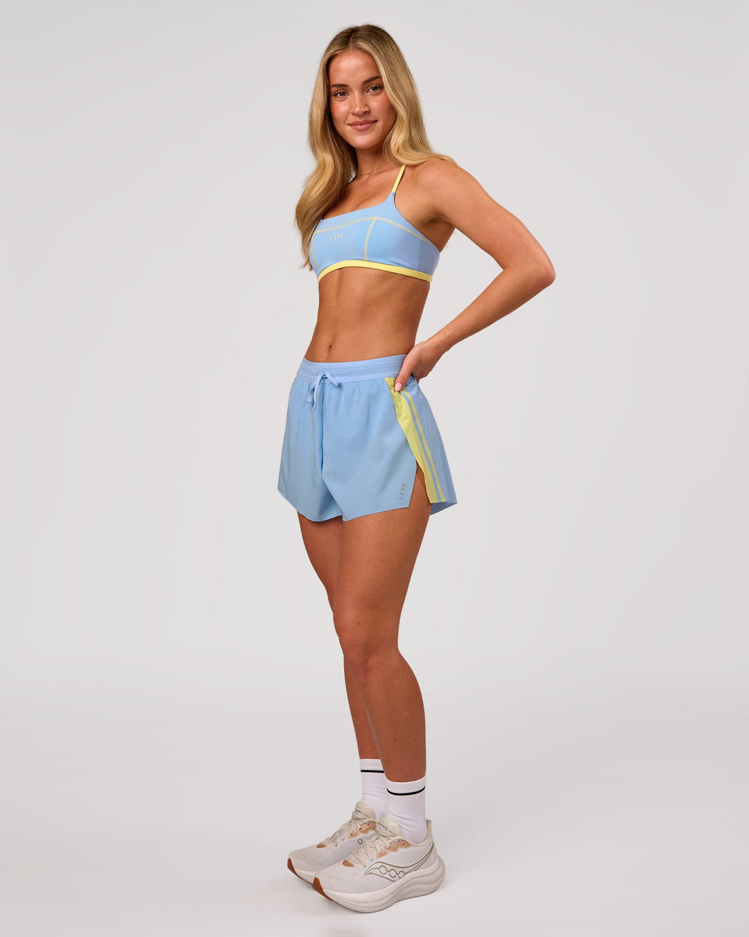 Woman wearing Accelerate 3" Force High-Rise Running Short - Open Air-Lemon | Model:Issy | Size:XS - view 7