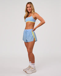 Woman wearing Accelerate 3" Force High-Rise Running Short - Open Air-Lemon | Model:Issy | Size:XS | Thumbnail Index: 6