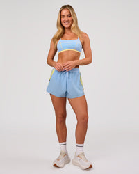 Woman wearing Accelerate 3" Force High-Rise Running Short - Open Air-Lemon | Model:Issy | Size:XS | Thumbnail Index: 7