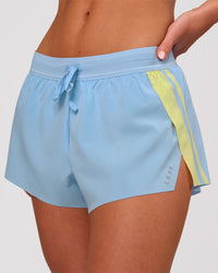 Woman wearing Accelerate 3" Force Mid-Rise Running Short - Open Air-Lemon | Model:Issy | Size:XS | Thumbnail Index: 0
