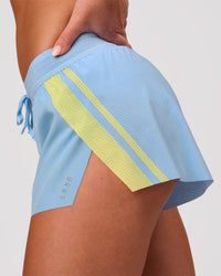 Woman wearing Accelerate 3" Force Mid-Rise Running Short - Open Air-Lemon | Model:Issy | Size:XS | Thumbnail Index: 1