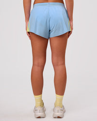 Woman wearing Accelerate 3" Force Mid-Rise Running Short - Open Air-Lemon | Model:Issy | Size:XS | Thumbnail Index: 2