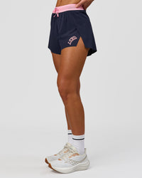 Woman wearing Accelerate 3" High-Rise Running Short - Future Navy-Varsity print | Model:Issy | Size:XS | Thumbnail Index: 4