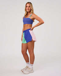 Woman wearing Accelerate 3" High-Rise Running Short - Power Cobalt-Prism | Model:Issy | Size:XS | Thumbnail Index: 1